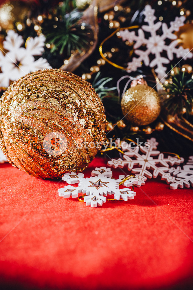 Christmas card with fir tree branch decorated with golden baubles ...
