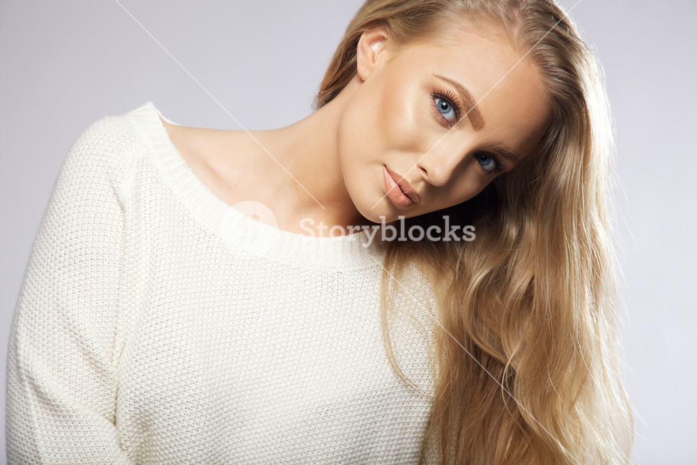Close-up portrait of a young woman with long hair, wearing a white ...