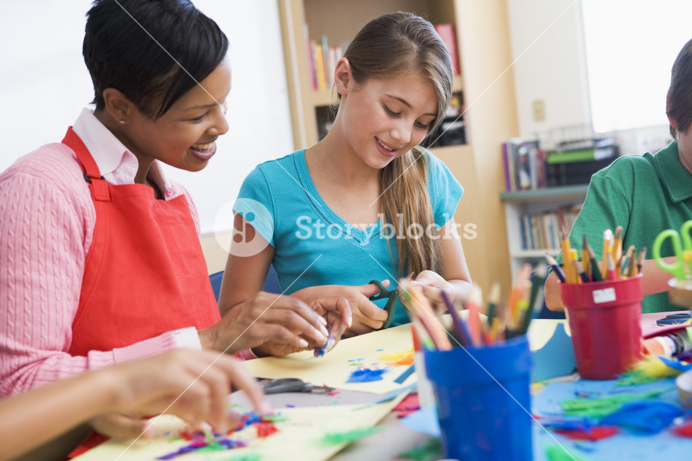 Elementary pupil in art class with teacher Royalty-Free Stock Photo SBI ...