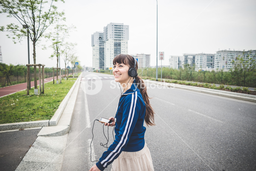 Woman enjoying music in an urban landscape