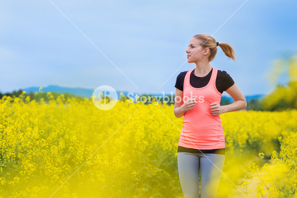 Spring Running Woman Young woman running in spring canola field Royalty-Free Stock Photo SBI ...