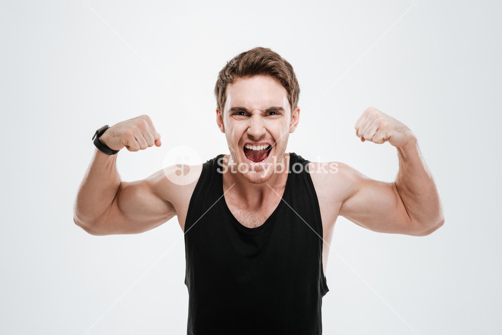 Young man showcasing his strength in a black t-shirt, white background ...