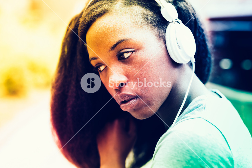 Portrait of young beautiful woman enjoying music with smartphone outdoors in the city - music, relaxation concept