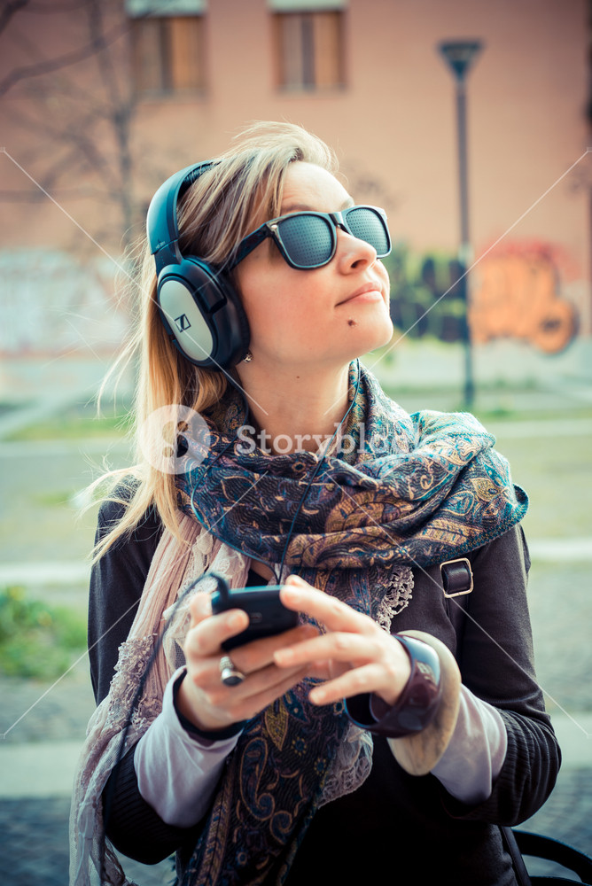 Young woman enjoying music in the city