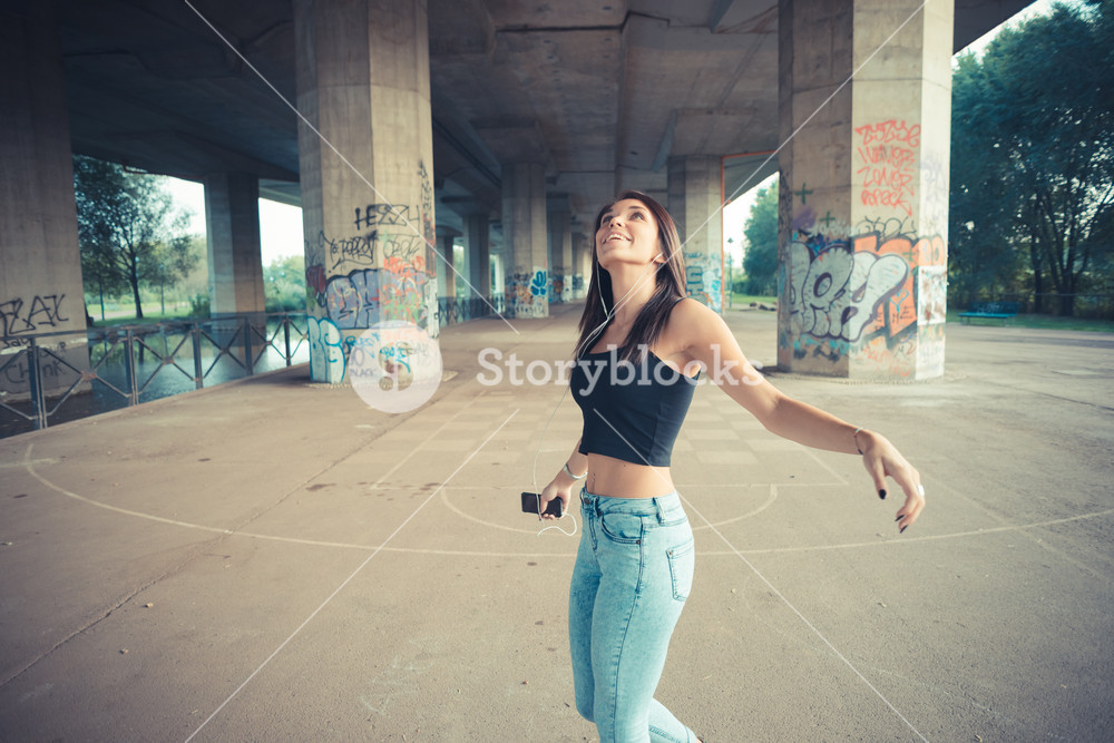 Stylish woman enjoying music outdoors
