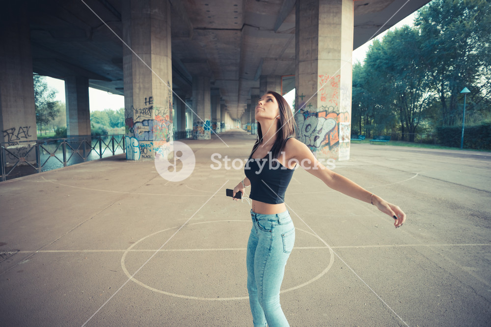 Stylish woman enjoying music outdoors