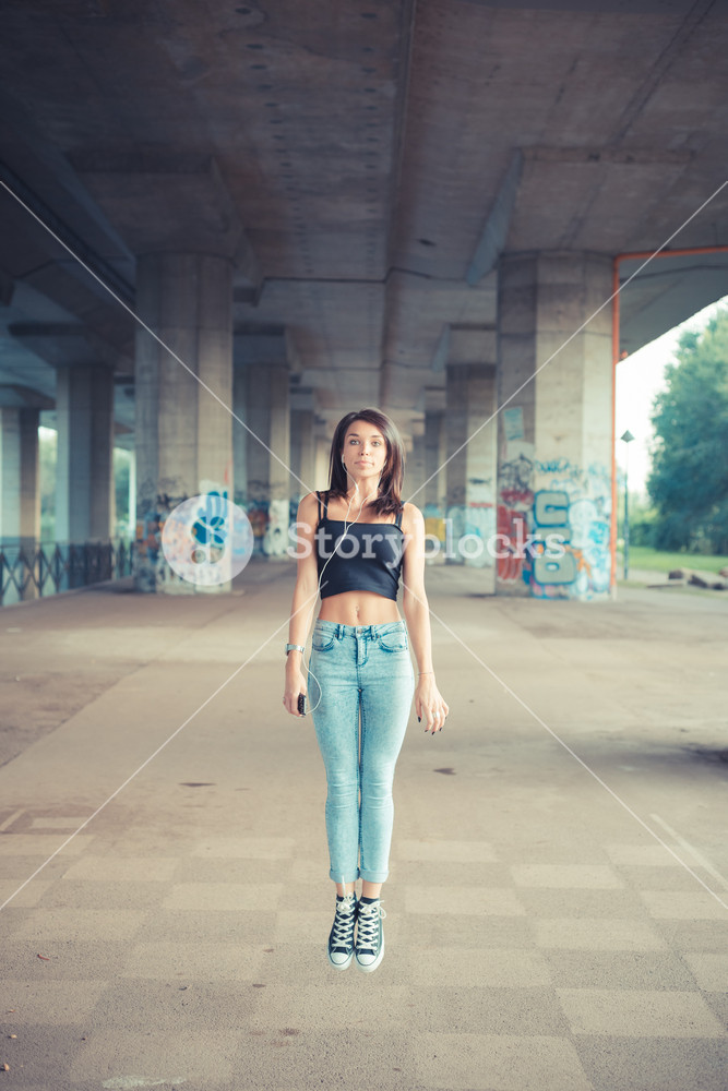 Stylish woman enjoying music outdoors