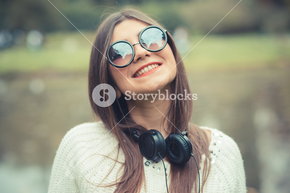 Young woman enjoying music outdoors with headphones