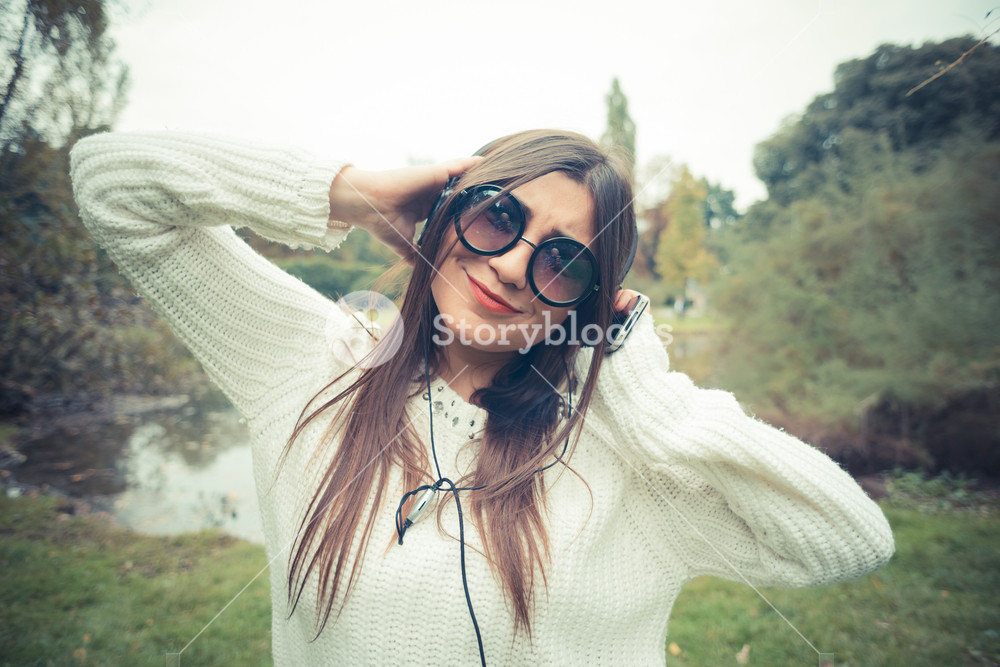 Young woman enjoying music outdoors with headphones