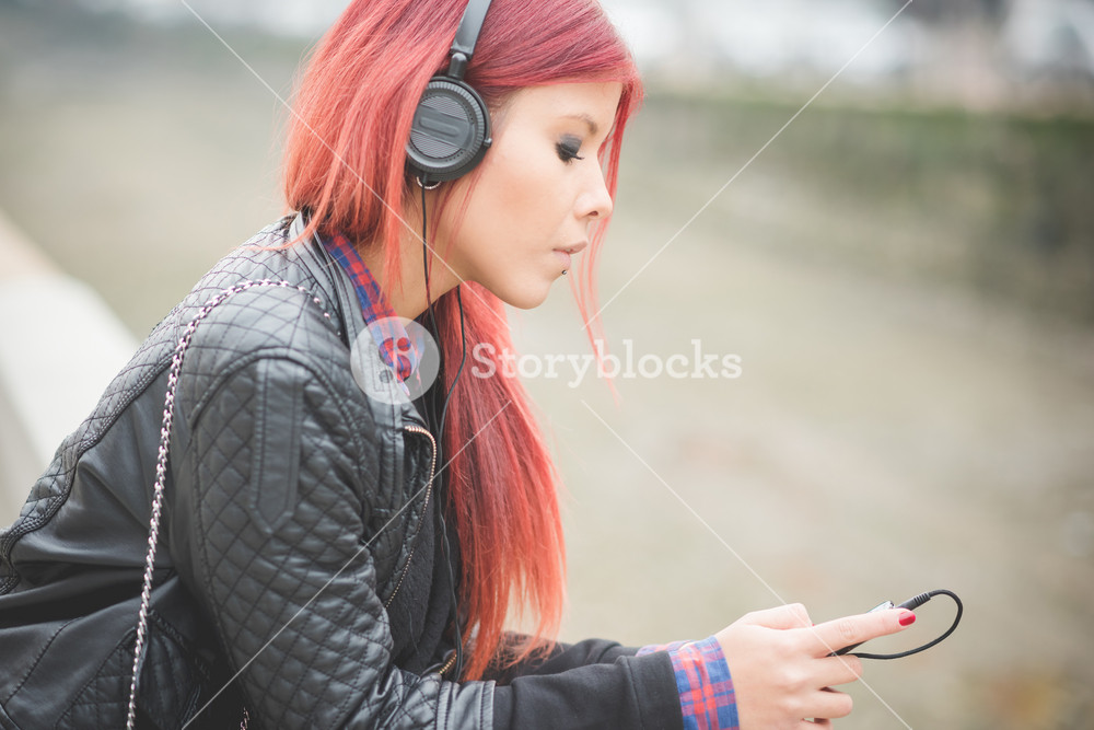 Vibrant Venezuelan woman enjoying city life in Milan, listening to music outdoors