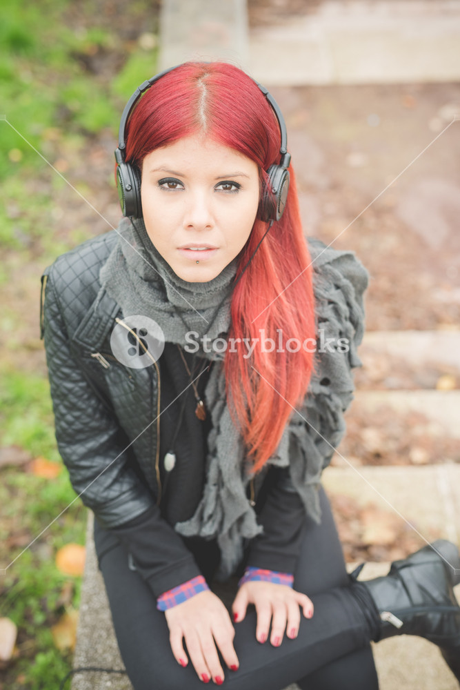 Vibrant Venezuelan woman enjoying city life in Milan, listening to music outdoors