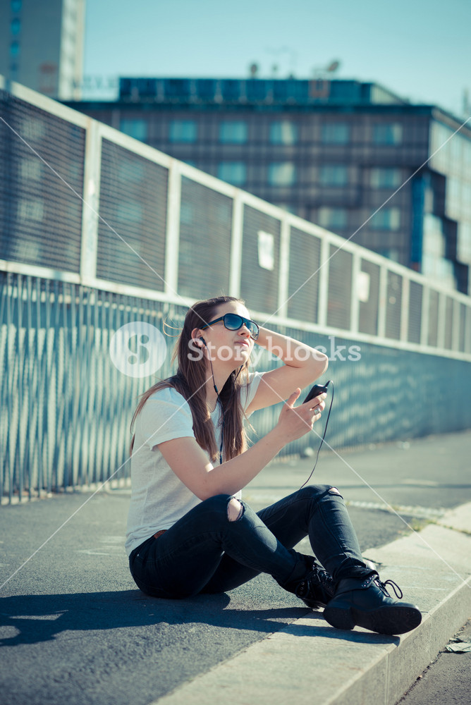 Young woman enjoying music in the city