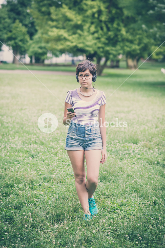 Young woman enjoying music in the city