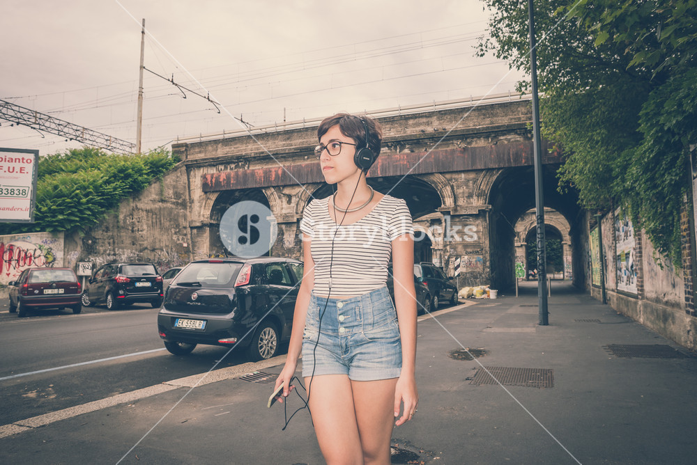 Young woman enjoying music in the city