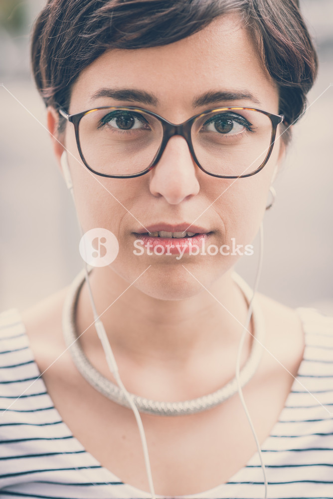 Young woman enjoying music in the city