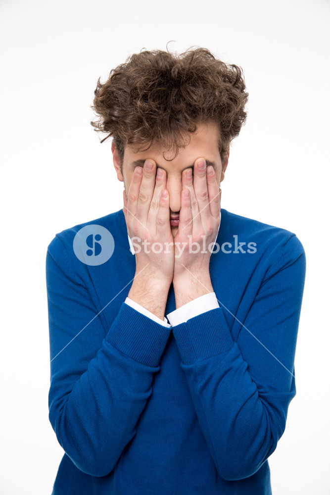 Man with curly hair covers his face with hands Royalty-Free Stock Photo ...