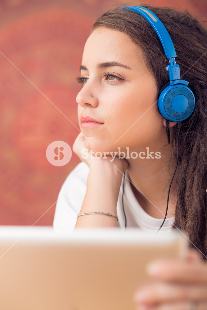 Portrait of a young woman enjoying music