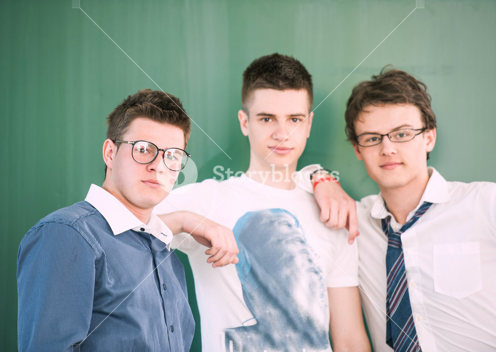 Three students standing in front of a blackboard Royalty-Free Stock ...