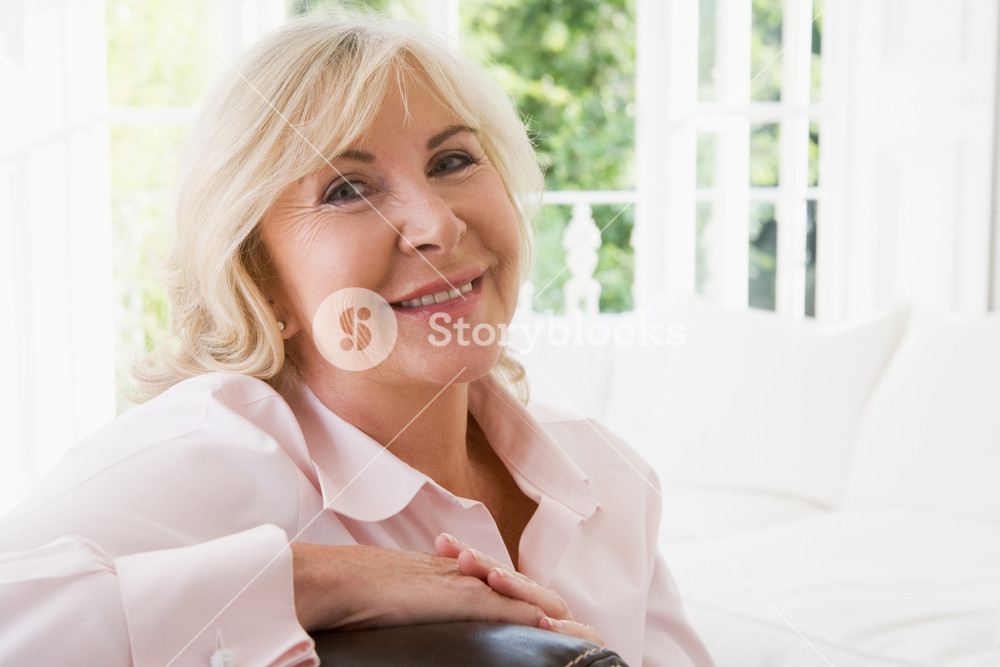 Woman in living room smiling Royalty-Free Stock Photo SBI-301053367 ...