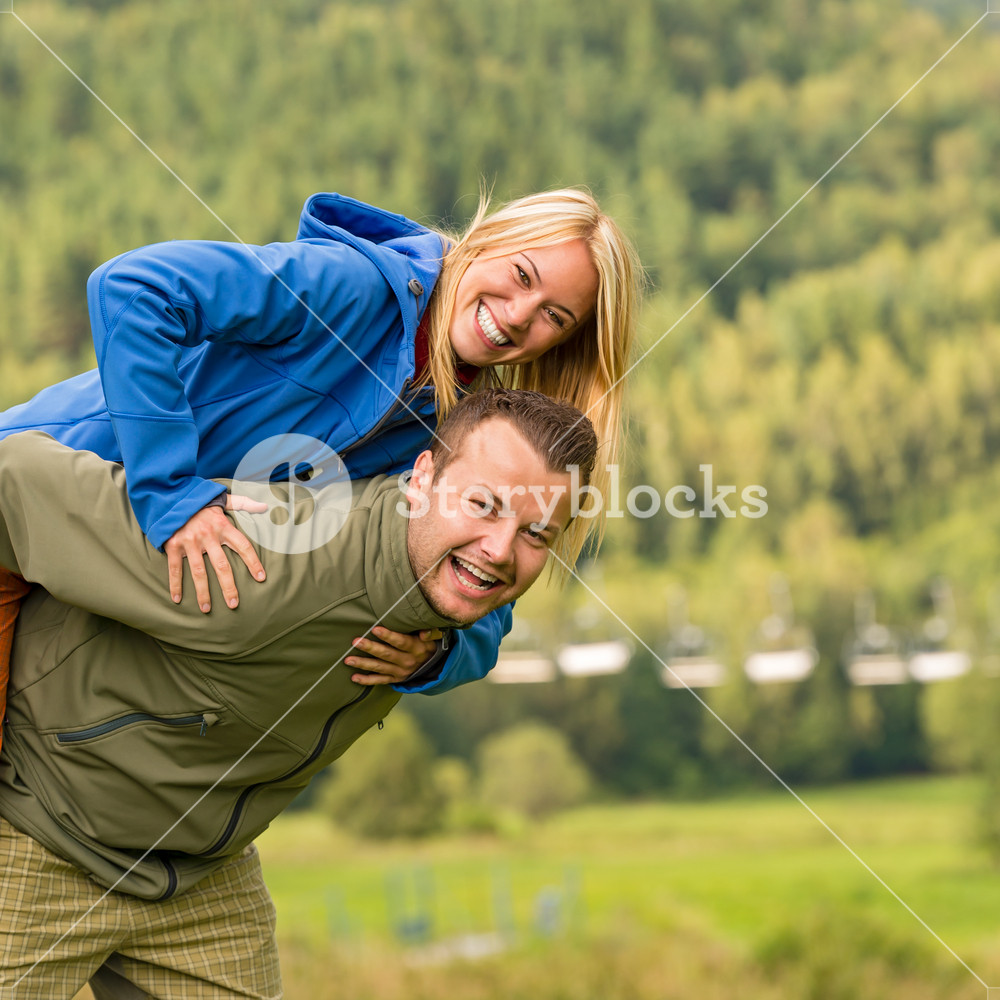 Happy couple enjoying piggyback ride in nature Royalty-Free Stock Image ...