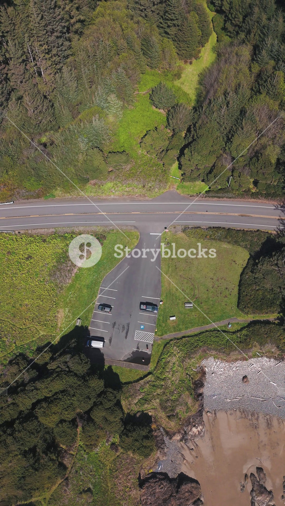 Vertical Aerial Nature Slow Motion Birds Eye Rising Drone Shot Of Parking Lot Near The Beach On The Oregon Coast On A Sunny Day