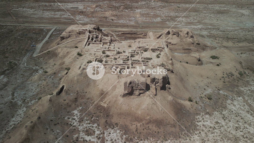 Fortress walls and palace remains show traces of ancient life. From this high angle, the city plan is clear. Once part of Chorasmia's oasis