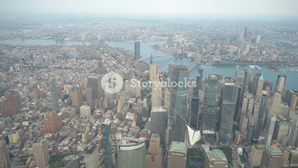 A breathtaking aerial view of Lower Manhattan with towering skyscrapers and the Brooklyn and Manhattan Bridges over the East River. The