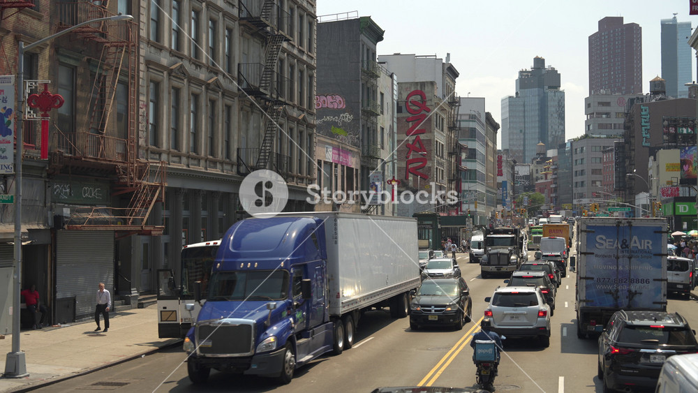 New York City, New York, USA - 08. 01. 2024: A crowded New York street with vehicles and pedestrians navigating the urban environment.