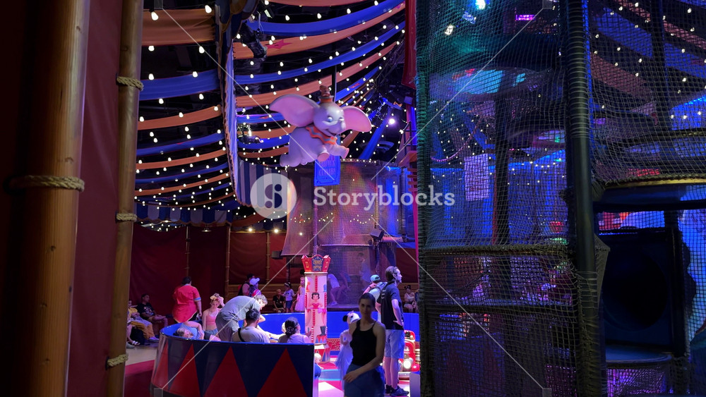 Orlando, Florida, USA - 05. 06. 2024: Kids explore an indoor playground inside the Storybook Circus tent at Adventure Park. The family area