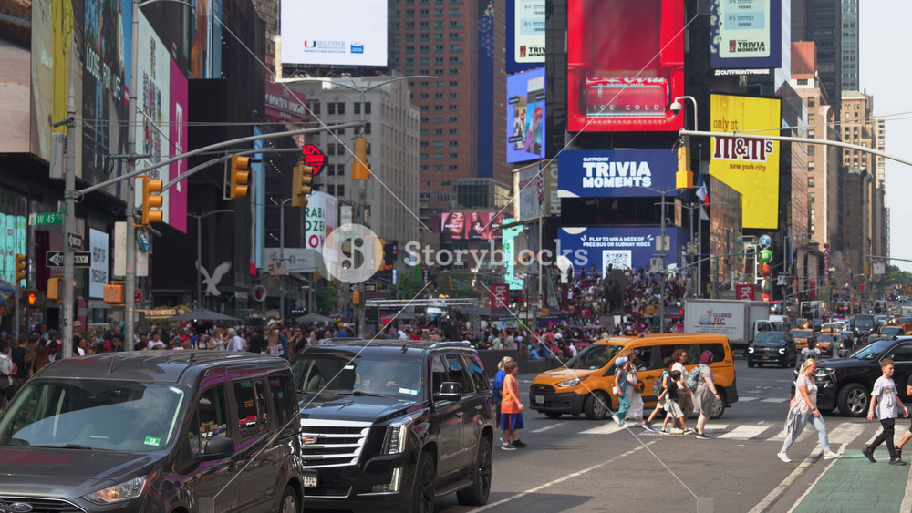 New York City, New York, USA - 07. 29. 2024: Manhattan's bustling streets come alive with crowds of pedestrians and a stream of cars. Bright