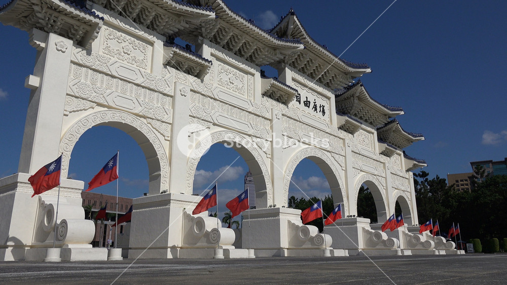 TAIPEI, TAIWAN 14 OCTOBER 2015: Taiwanese flags wave at the entrance gate of Chiang Kai-shek memorial hall in Taipei, Taiwan