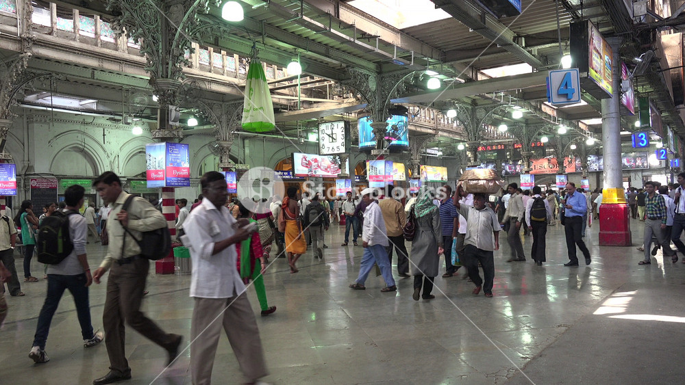 MUMBAI, INDIA NOVEMBER 2014: Crowds of train passengers commute during rush hour inside the Victoria Terminus railway station in Mumbai, public transport and travel in India