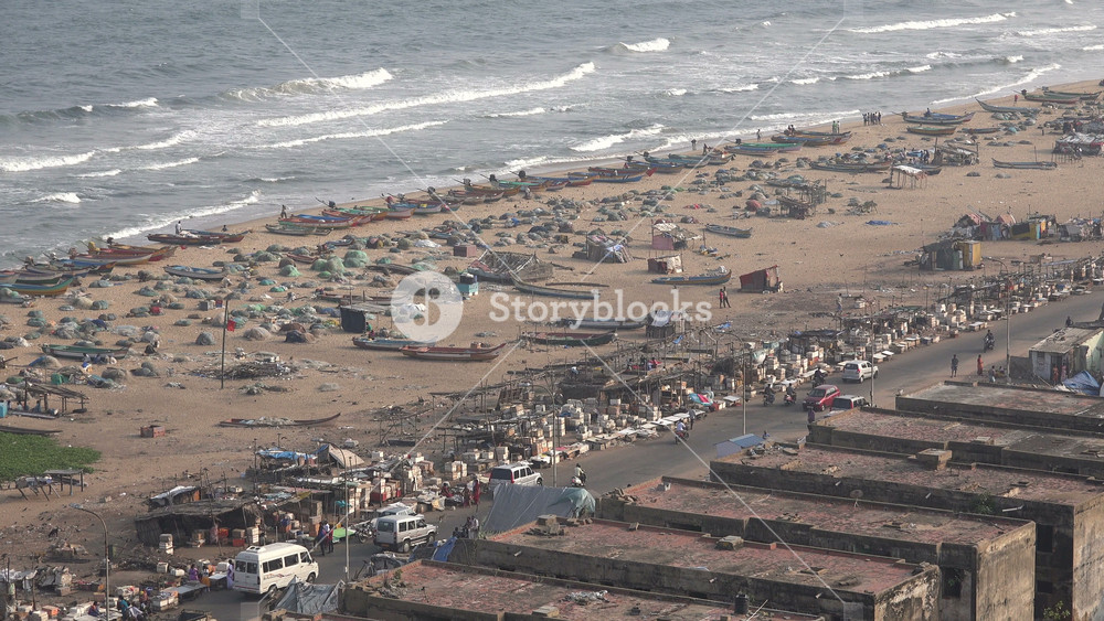 CHENNAI, INDIA NOVEMBER 2014: Overview of a part of the Marina Beach, where fishing boats have returned from a day at sea, in Chennai, employment and leisure in India