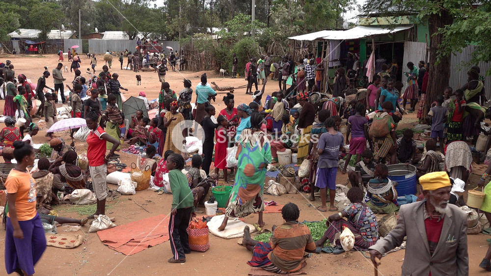 OMO VALLEY, ETHIOPIA 4 APRIL 2019: Bustling market scene of local Hamar tribal people in the Omo Valley, traditions and customs in South Ethiopia Africa