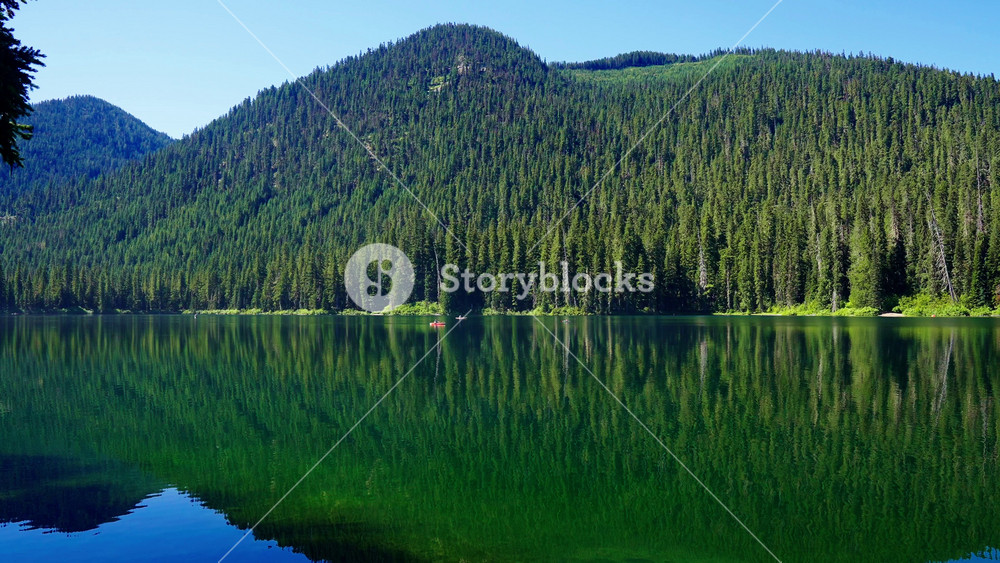 Landscape of Cooper lake mountain. Kayak boat. Nature landscape. Cooper Lake in Cascade Mountains. Scenic nature with kayak boat at Cooper