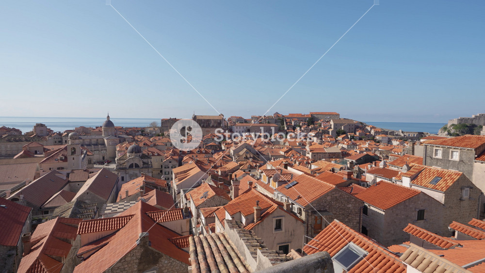 Dubrovnik Croatia Ancient City on Adriatic Sea. Pan Left Across Red and Orange Roofs in Old Town View From City Walls Above Early Morning Summer