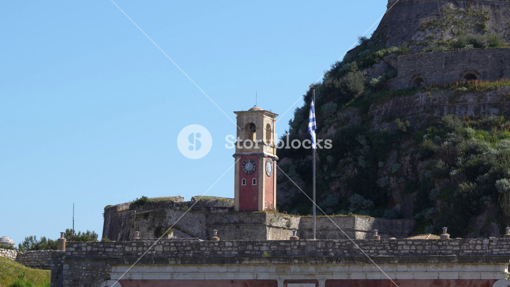 The Old Fortress of Corfu Greece Citadel. Close Up Clock Tower Greek Flag Waving. Mediterranean Greek Island Holiday Vacation Historic 15th century