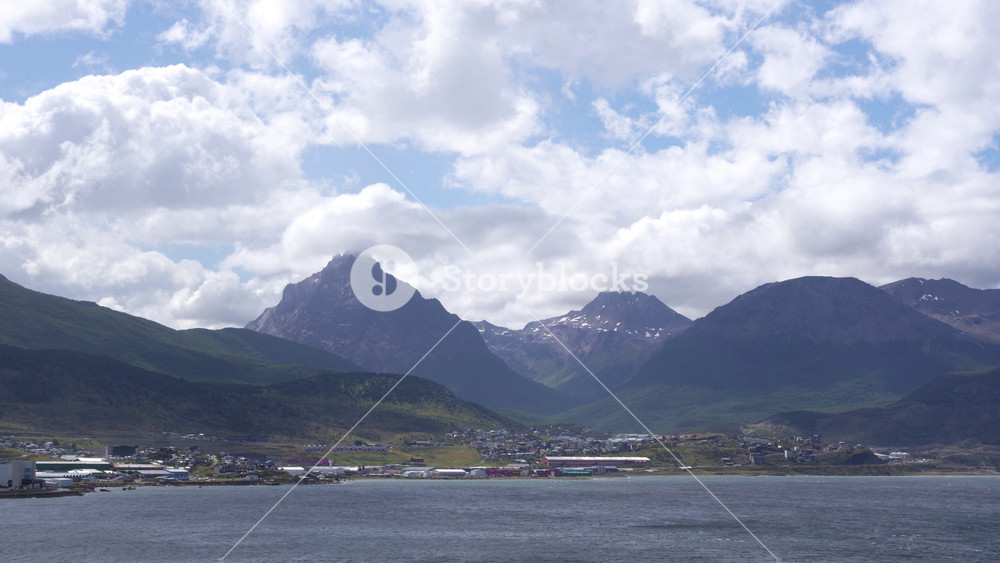Port of Ushuaia Argentina, Tierra del Fuego Near Antarctica. View From Cruise Ship. Stunning Wide View Mountain Range, Blue Sky and Clouds, Buildings