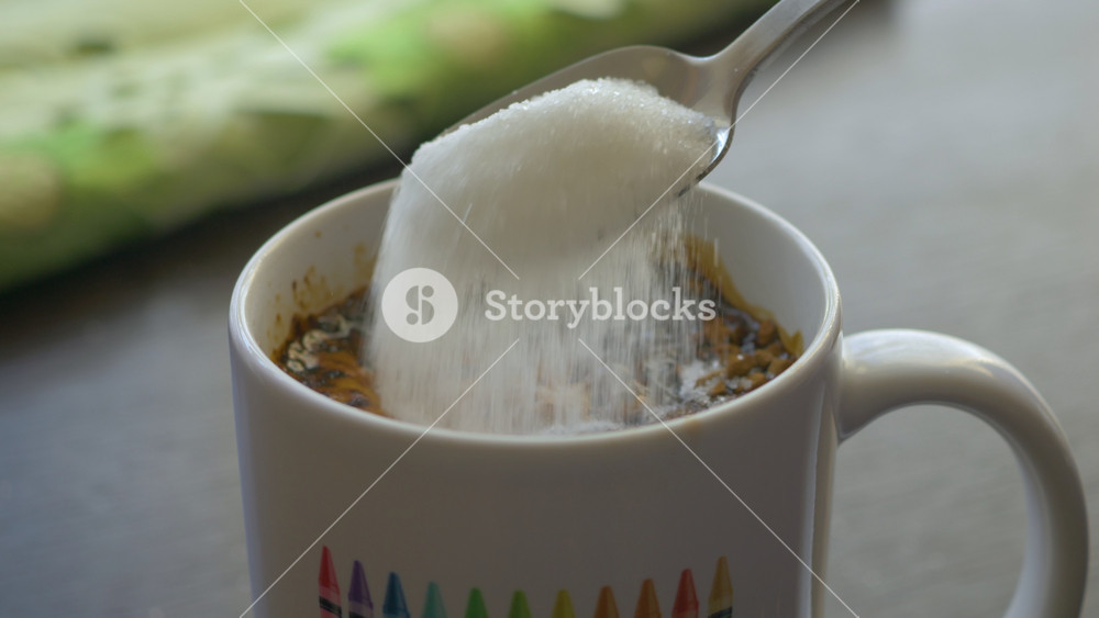 Slow Motion Putting Sugar in to Black Coffee. Sugar Falling Down Into Coffee Cup. Coffee Caffeine Addiction Junk Food. Concept of Unhealthy Eating, Diabetes, Obesity, Heart Disease.
