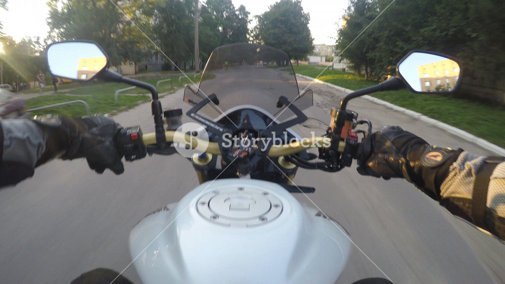 Point of view of a motorcycle rider rides in rural road in high speed. The viewpoint of motorcyclist driving in the city streets. Pov Close up