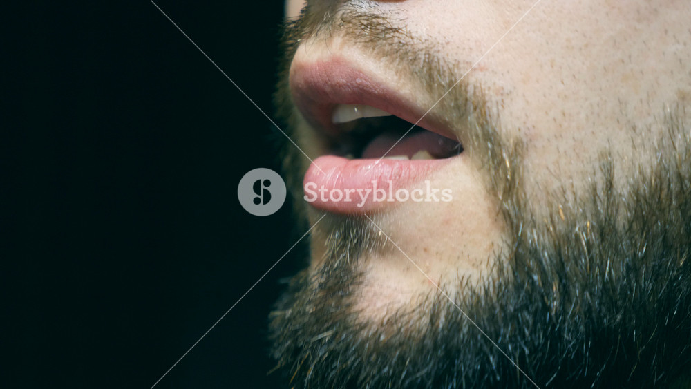 Mouth of male singer singing song at sound studio. Unrecognizable young man recording new melody or song. Working of creative musician. Show business concept. Slow motion
