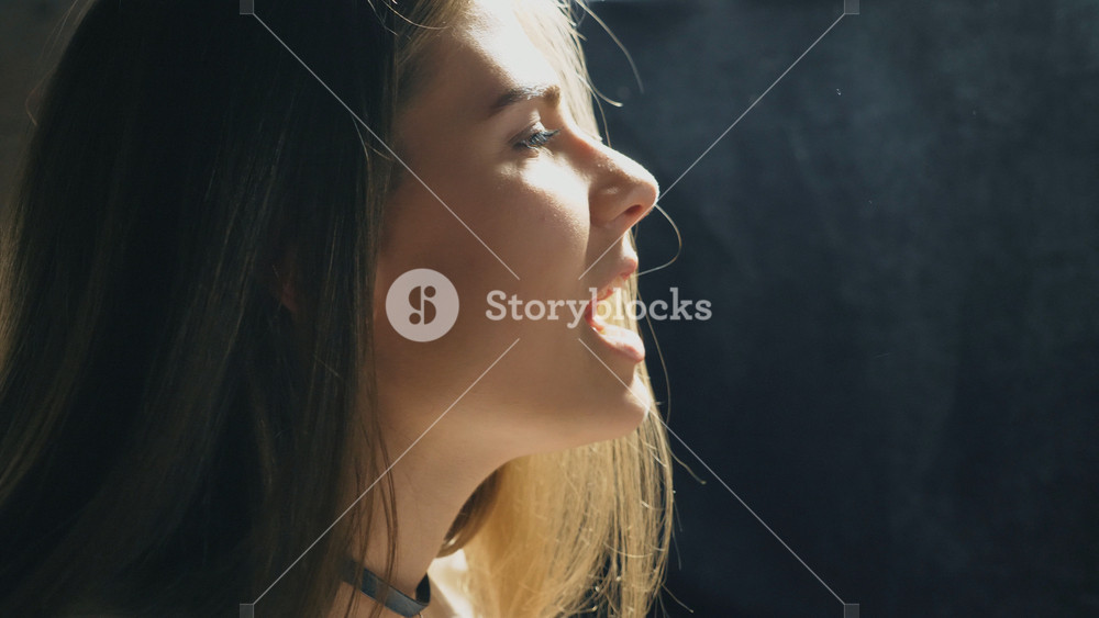 Profile of beautiful girl singing in sound studio. Young singer emotionally sings song. Working of creative musician. Show business concept. Slow motion Close up
