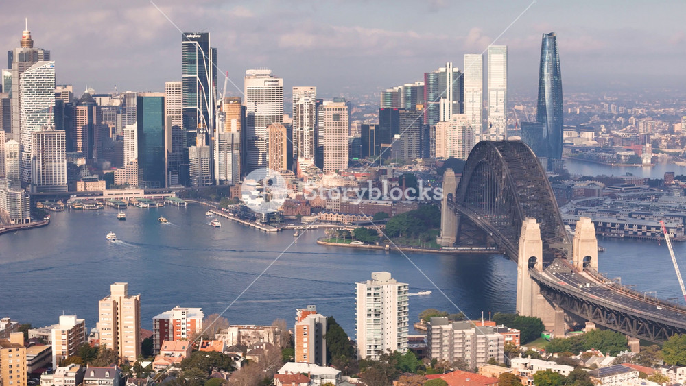 Aerial drone view of Sydney City, the Sydney Harbour and Harbour Bridge, NSW Australia on a partly cloudy morning in August 2024