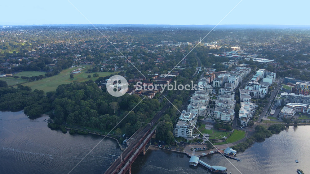 Aerial drone view of Rhodes, an Inner West suburb of Sydney along Parramatta River looking across Ryde Bridge toward Meadowbank in April 2022