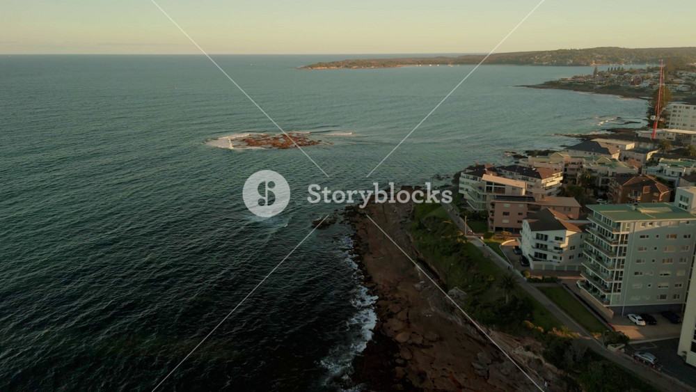 Aerial drone view of Cronulla heading toward Shark Island in Sutherland Shire, South Sydney, NSW Australia during late afternoon summer in February 2025
