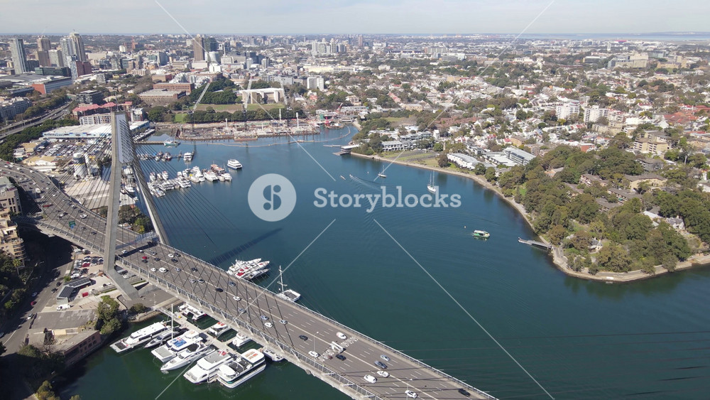 Aerial drone view of Anzac Bridge across Johnstons Bay between Pyrmont and Glebe Island in Rozelle, Sydney NSW on a sunny morning