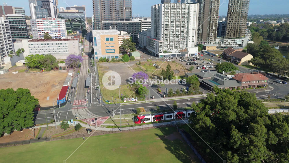 Aerial drone view of a light rail vehicle at Parramatta cbd in Western Sydney, NSW, Australia as it turns onto Harris Street